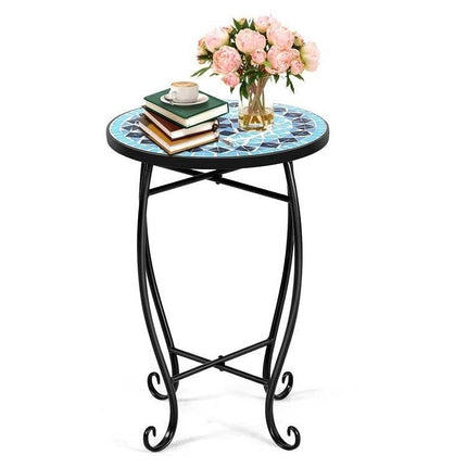 Small round table with decorative mosaic top, black metal legs, and a vase of pink flowers on a white background.