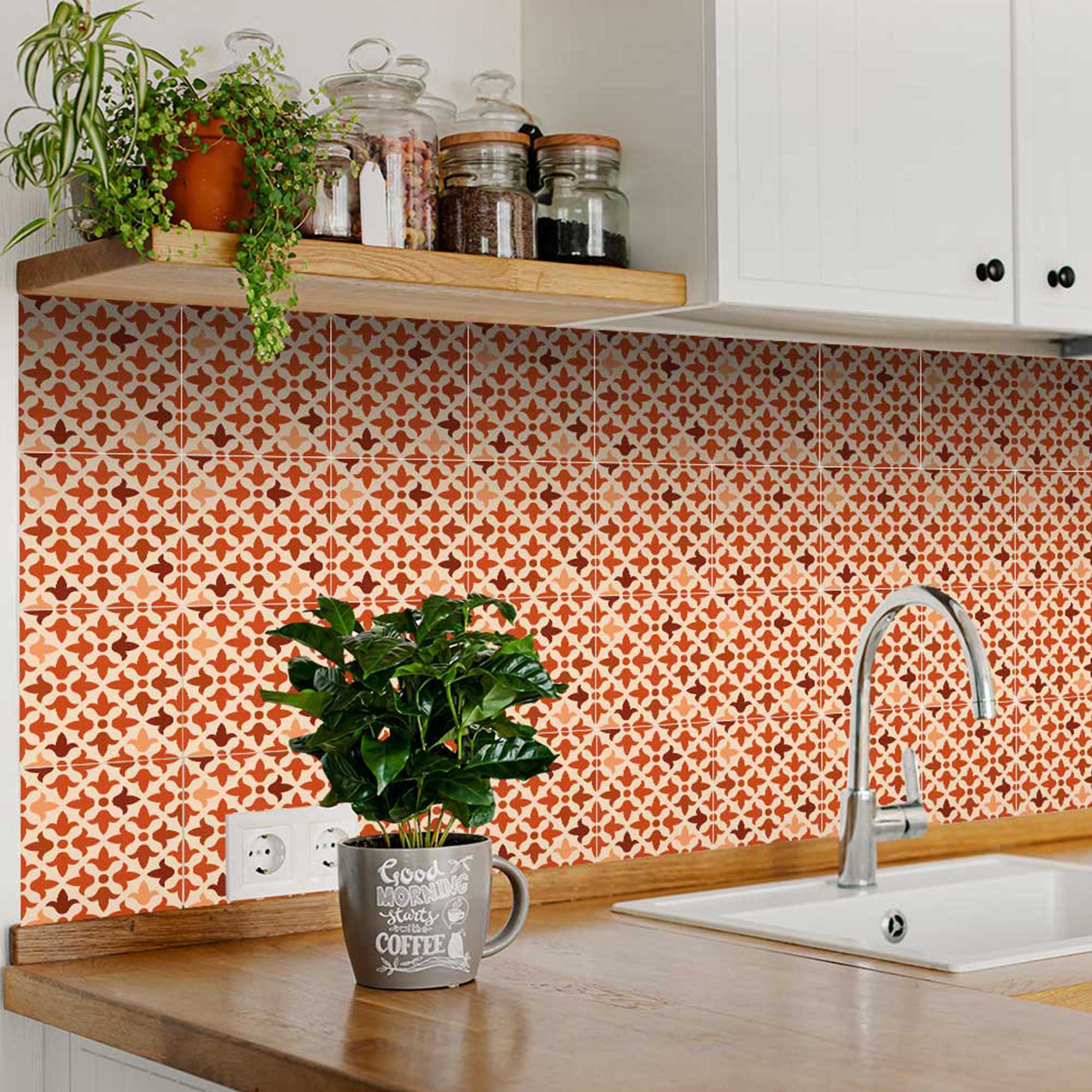Kitchen with patterned orange backsplash, plants, and a sink.