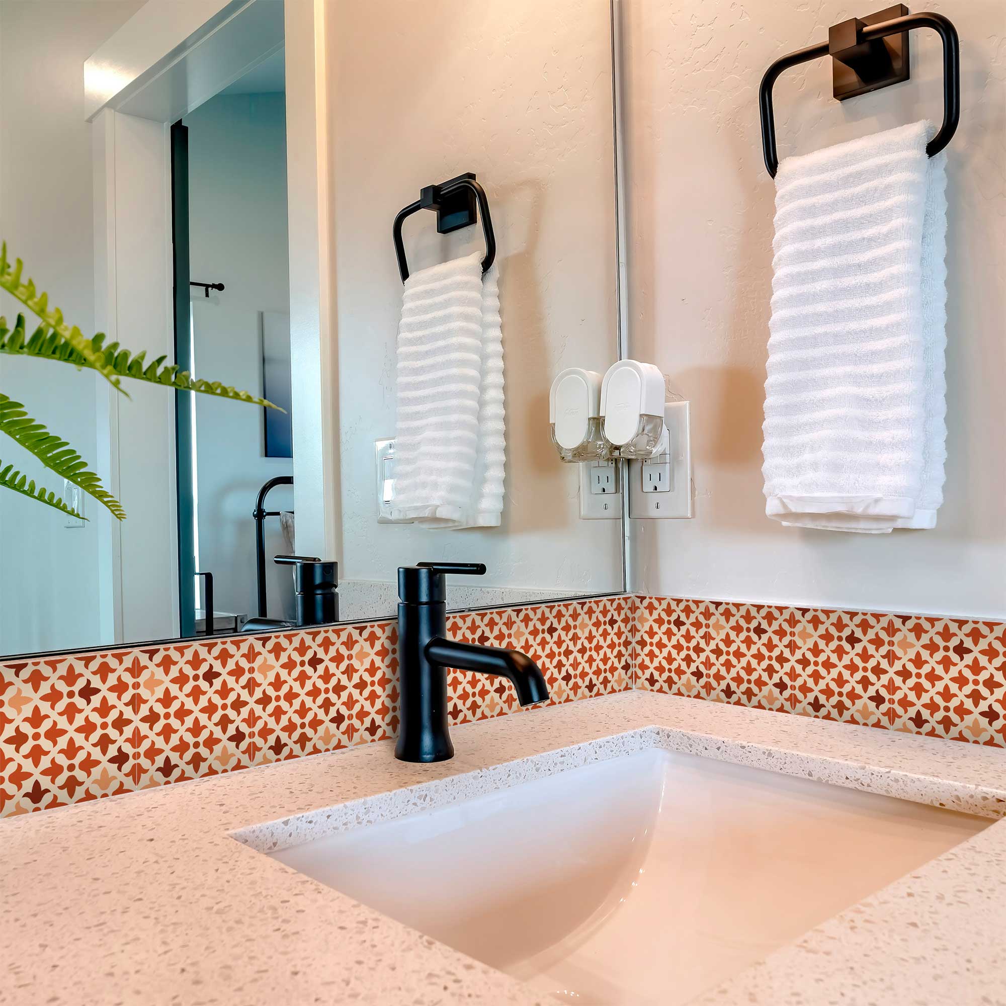 Bathroom with a sink, mirror, and decorative tiles.