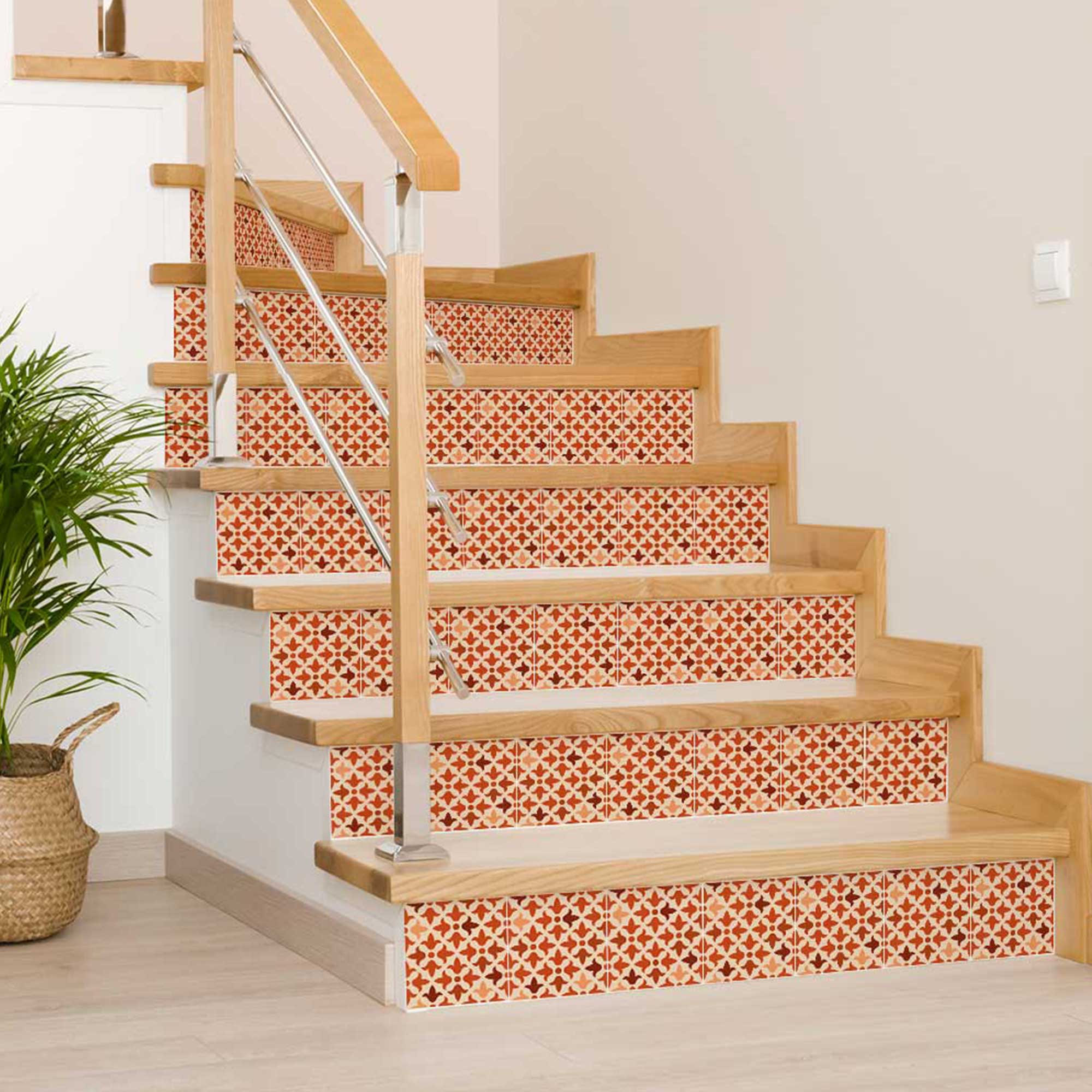 Wooden staircase with decorative red and white patterned risers in a home setting.
