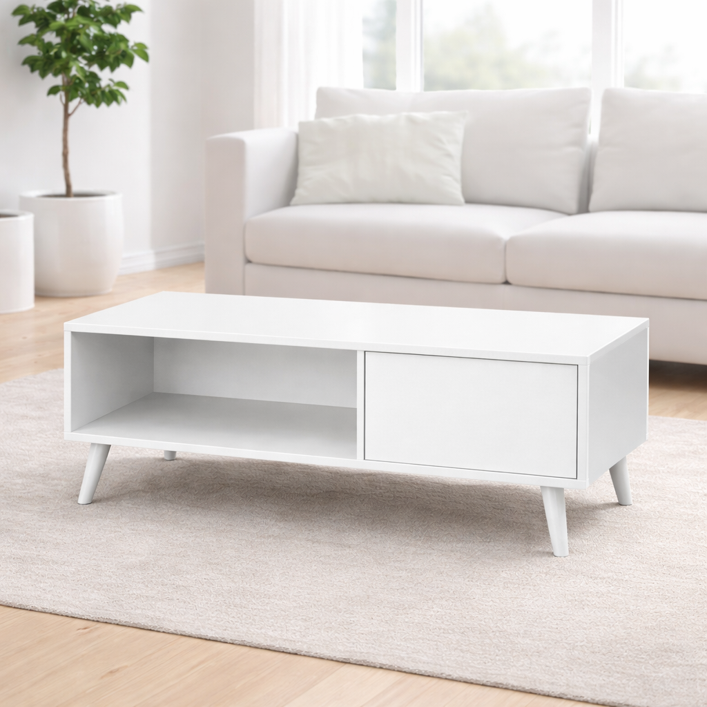 White coffee table in a living room with a white sofa and plant.