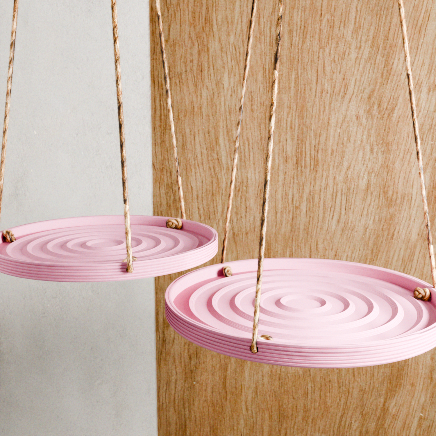 Pink hanging plates with a wooden background