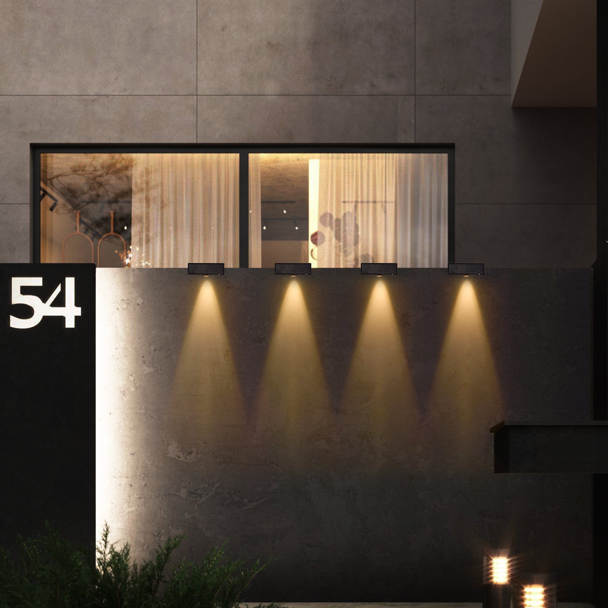 Modern building exterior with illuminated windows and decorative lights.