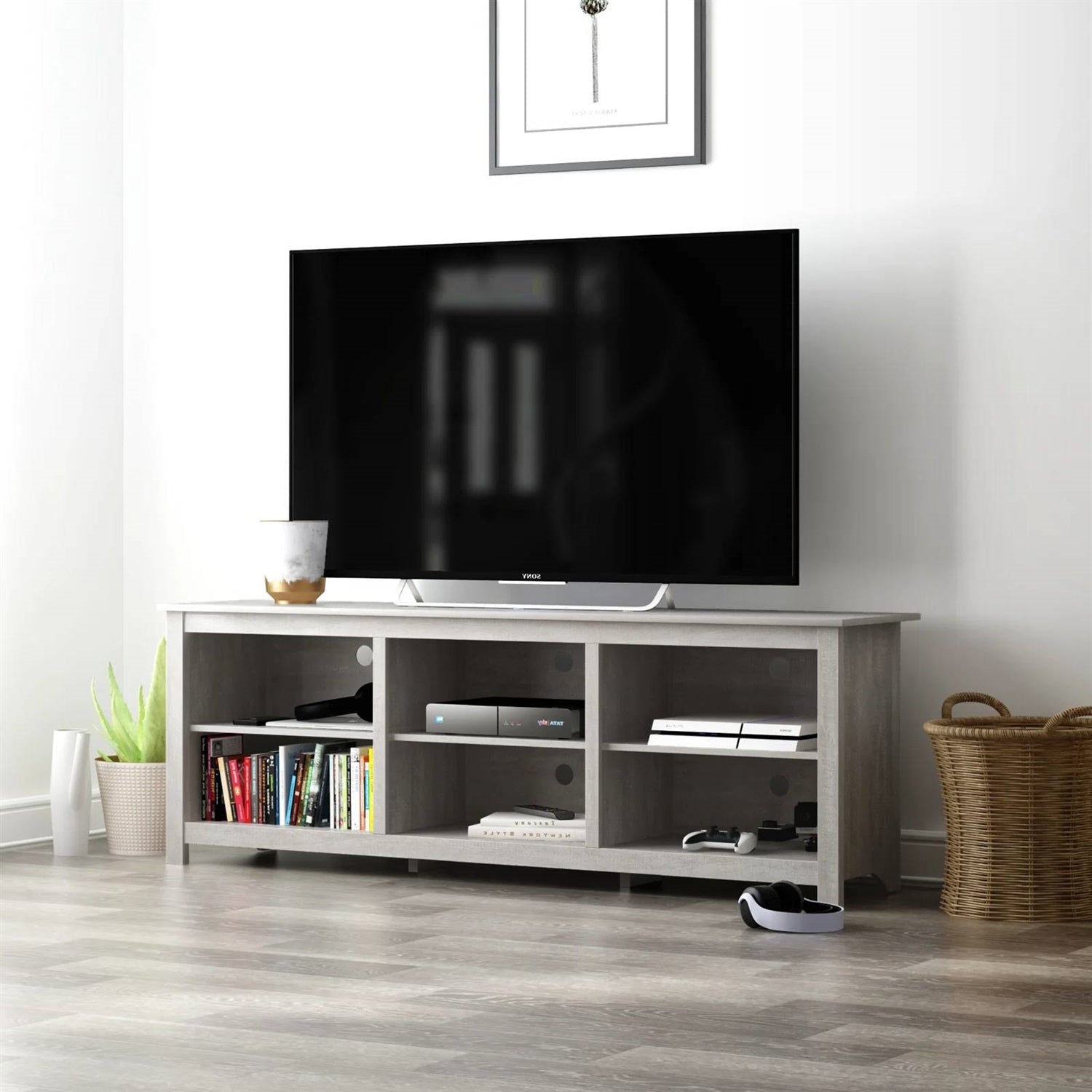 TV on a wooden stand with shelves in a room setting