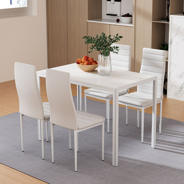 Dining room with a white table and chairs on a gray rug.