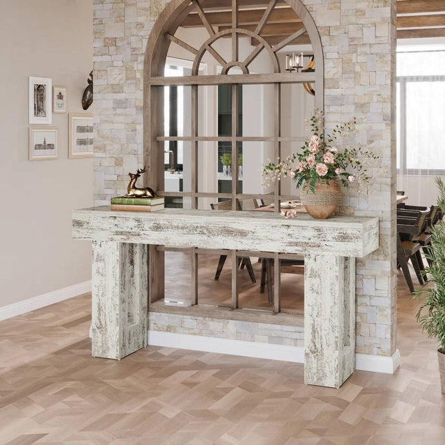 Wooden console table with decorative items in a room with a mirror and wall art.
