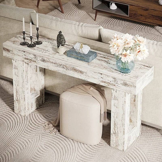 Wooden console table in a living room with decorative items.