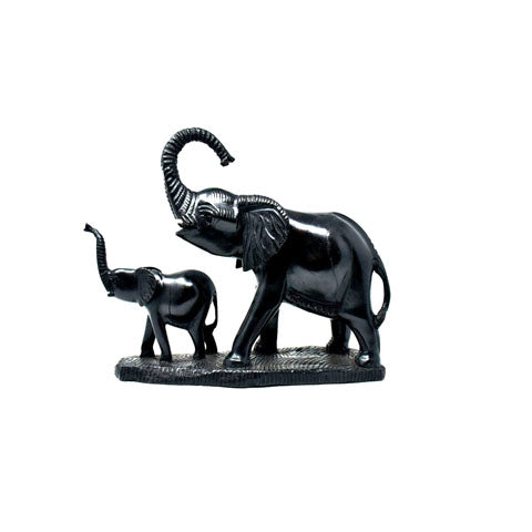 Black stone sculpture of two elephants on a white background
