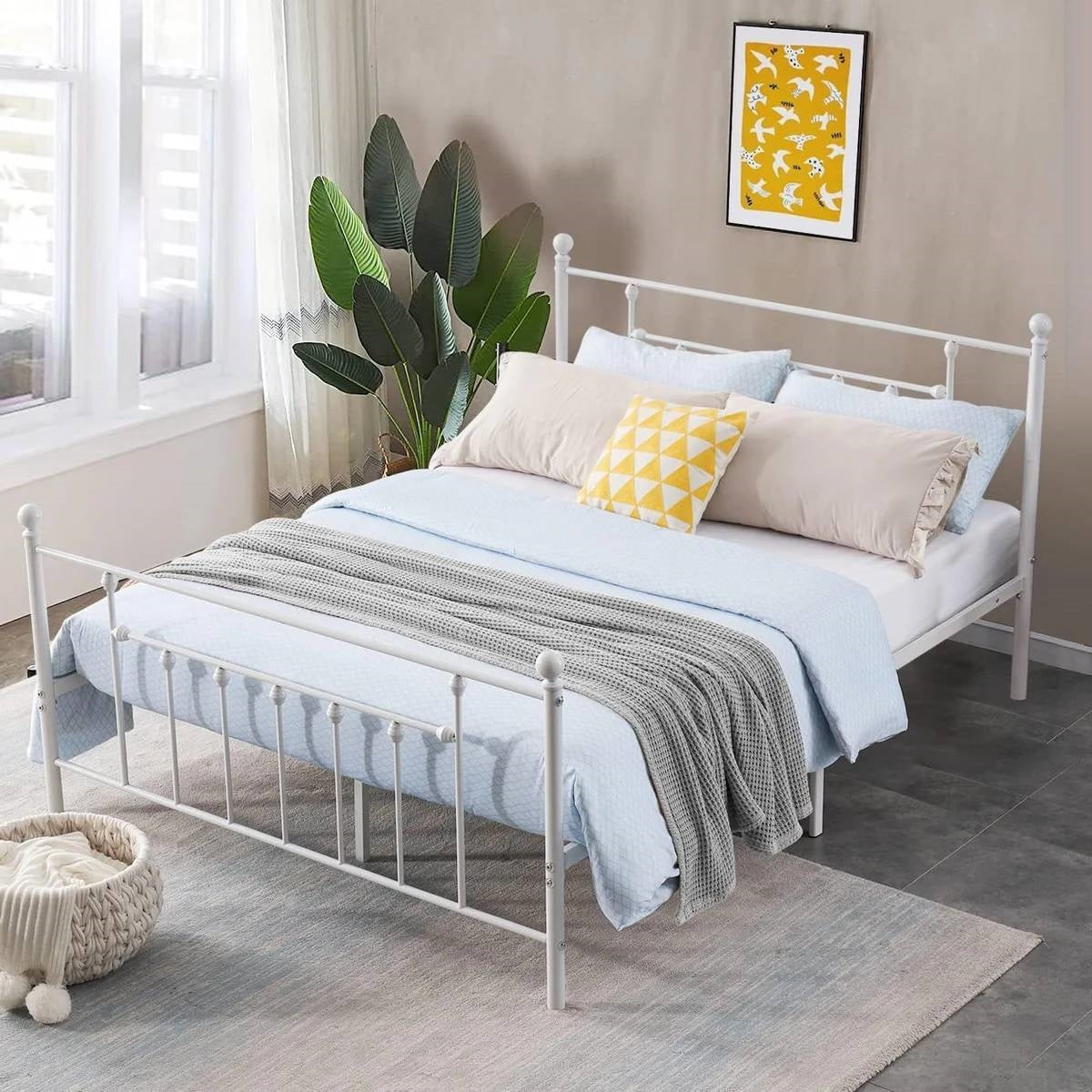 White metal bed with bedding in a bedroom setting