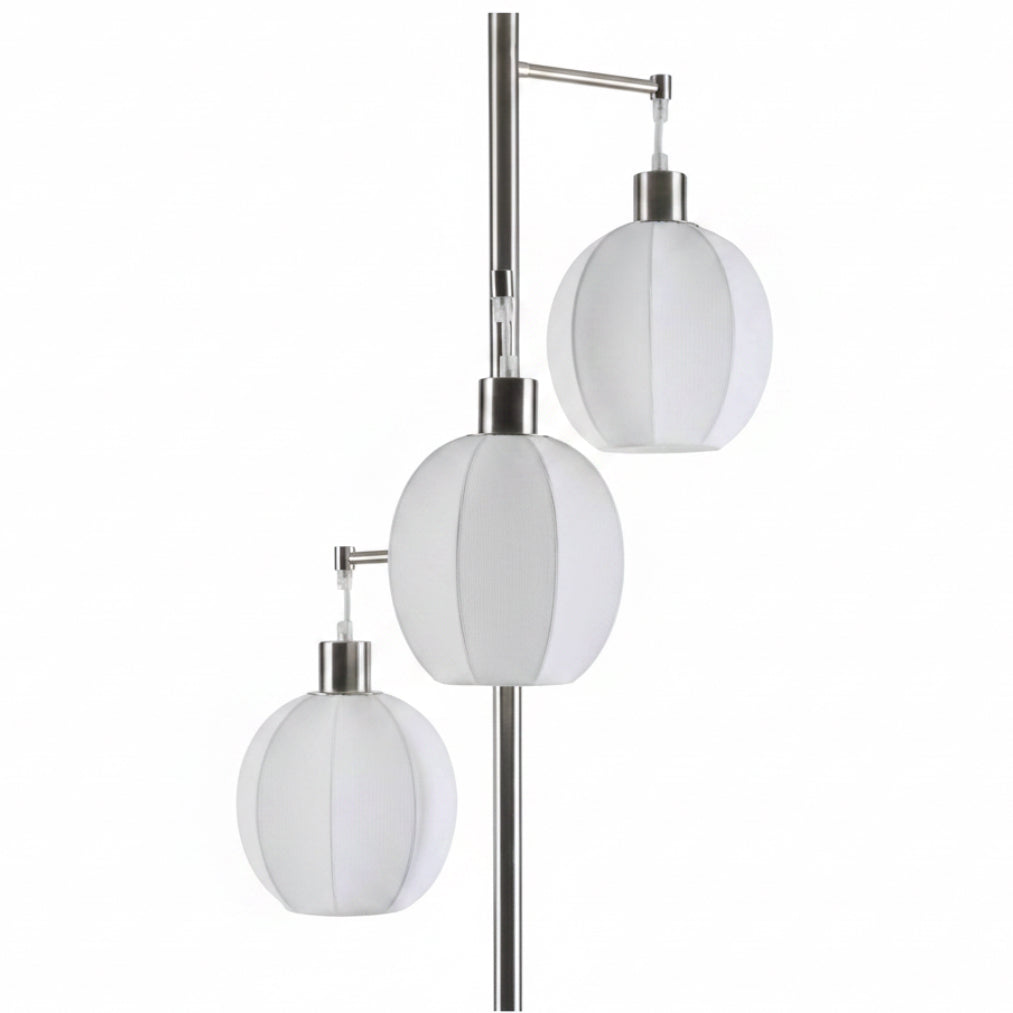 Modern floor lamp with three white glass shades on a white background