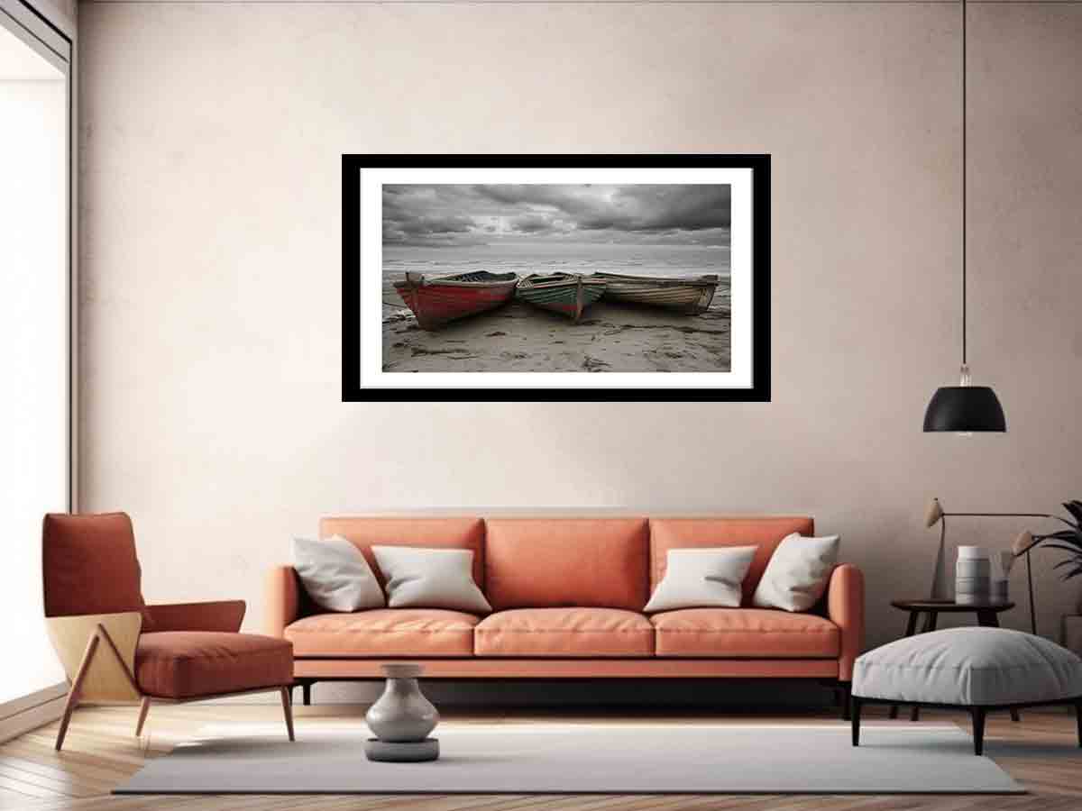 Living room with an orange sofa, armchair, and framed artwork of boats on a beach.