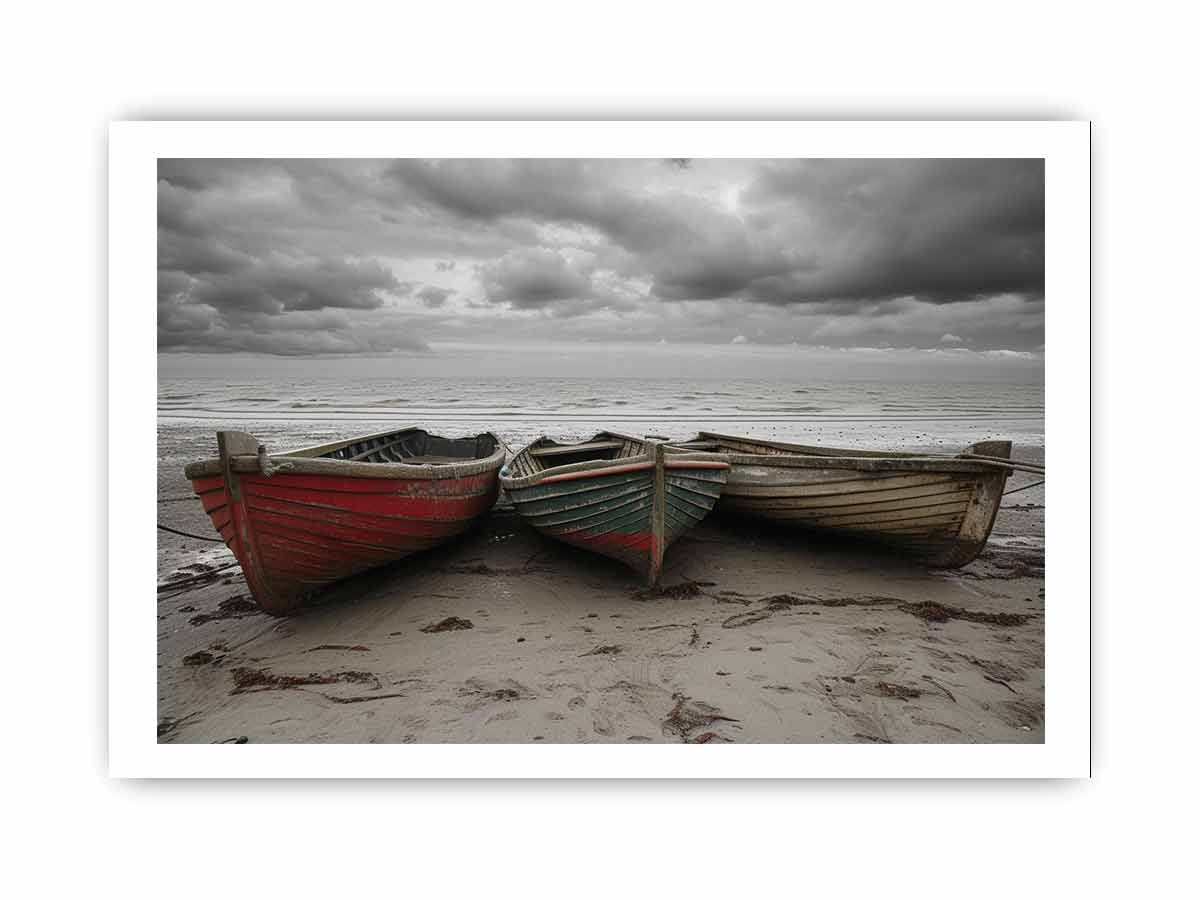Three old boats on a beach with a stormy sky