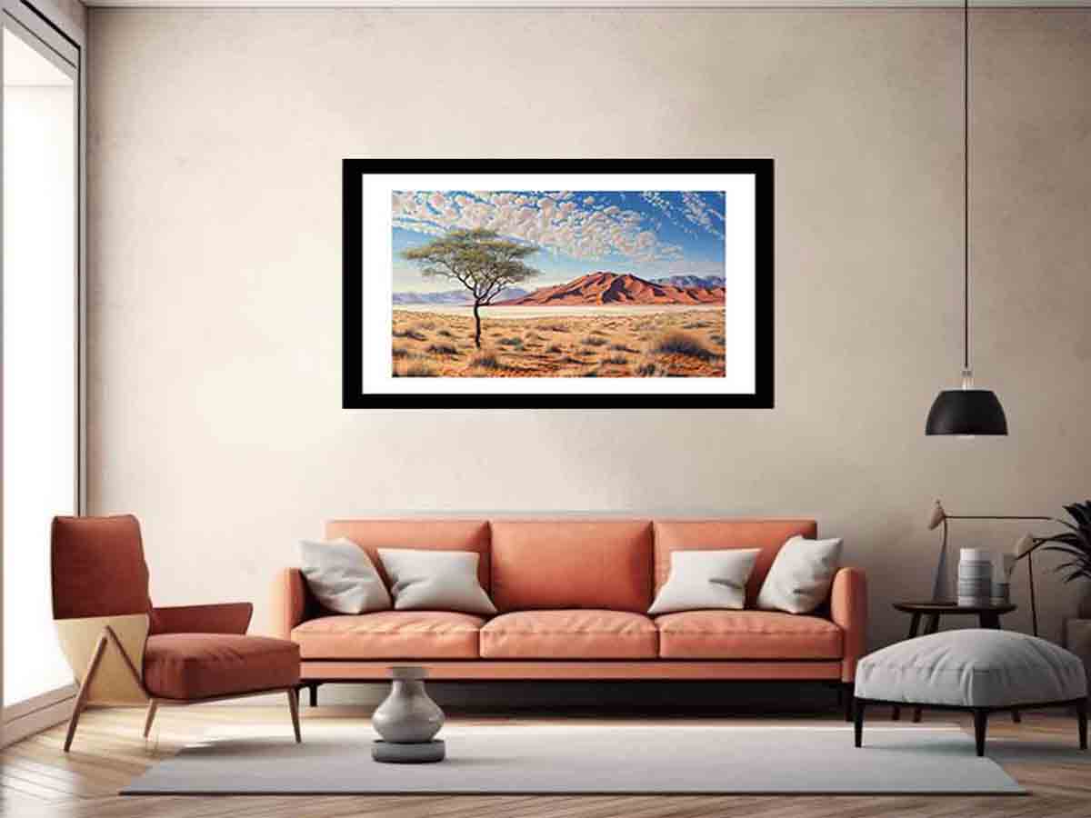 Framed artwork of a desert landscape with a tree on a beige wall above a modern living room.