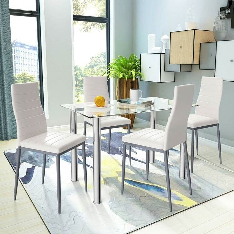 Modern dining room with a glass table and white chairs.