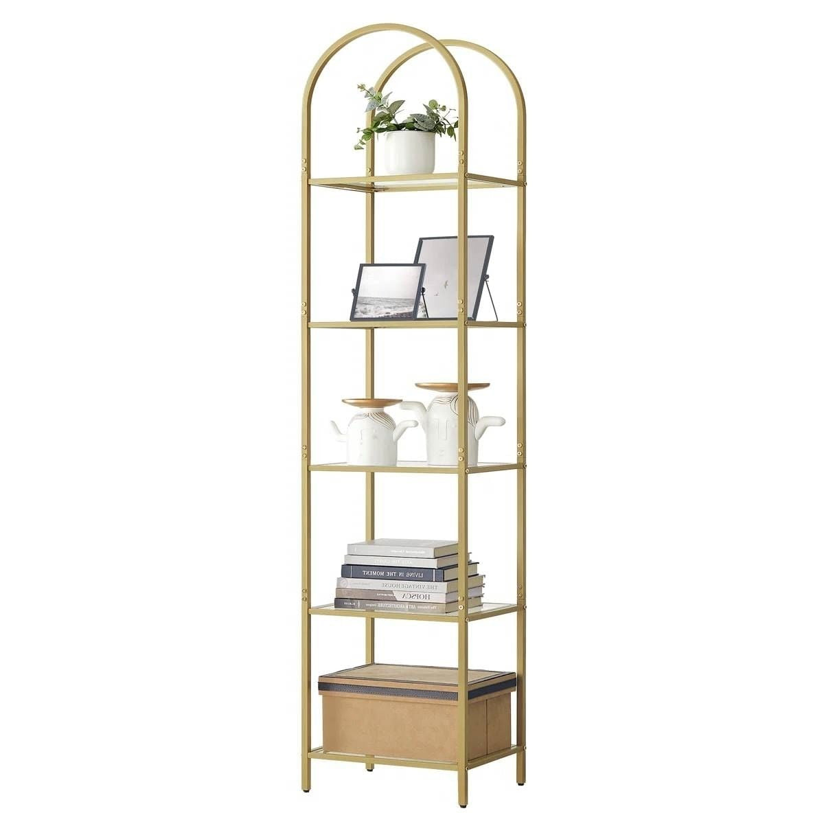 Gold metal bookshelf with decorative items on a white background