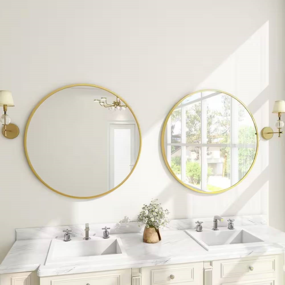 Bathroom with two round gold-framed mirrors above a double sink vanity.