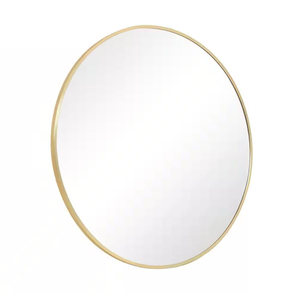 Round mirror with a gold frame on a white background