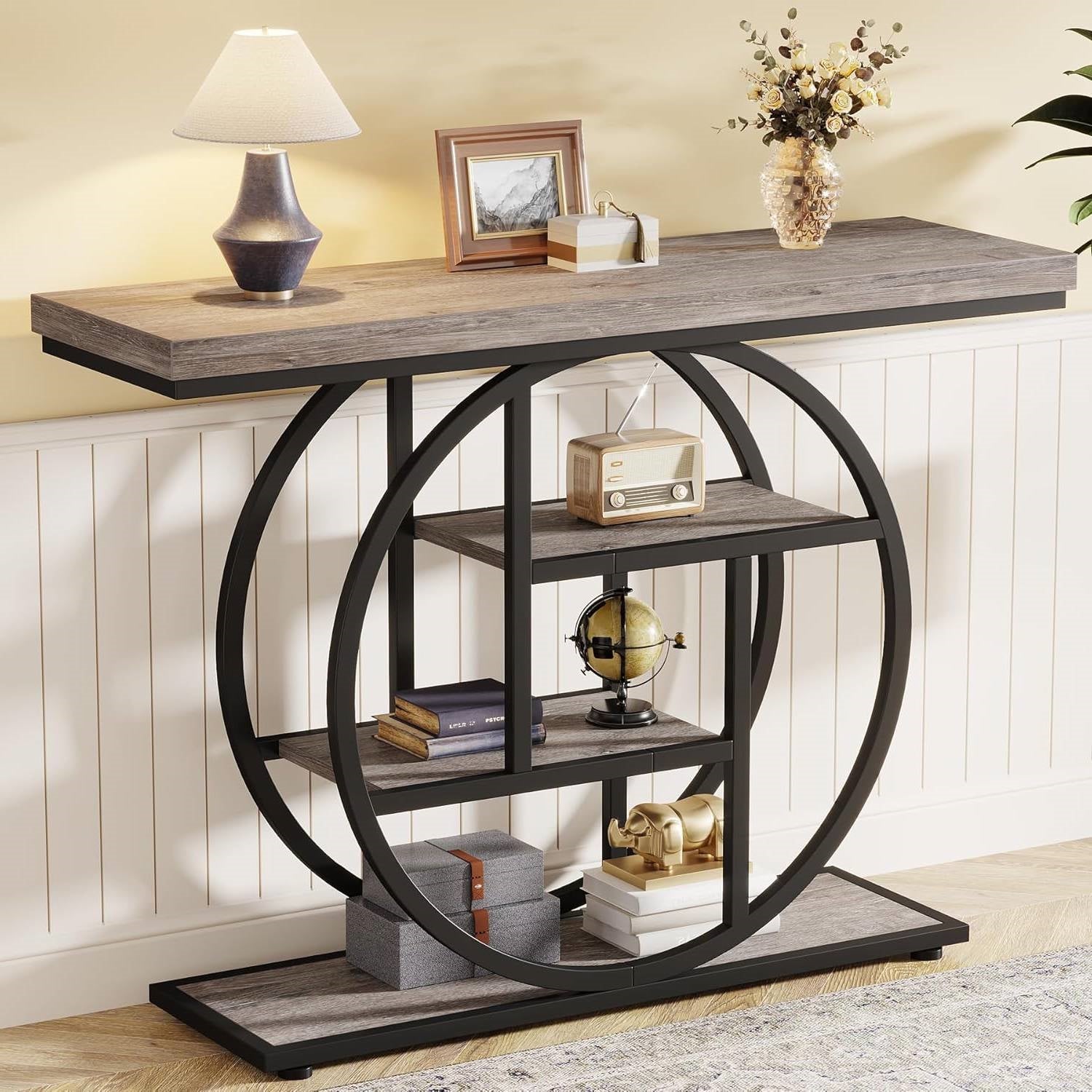 Console table with wooden top and circular metal frame in a room setting.