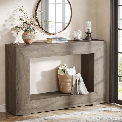 Wooden console table with decorative items in a room with a mirror and window.