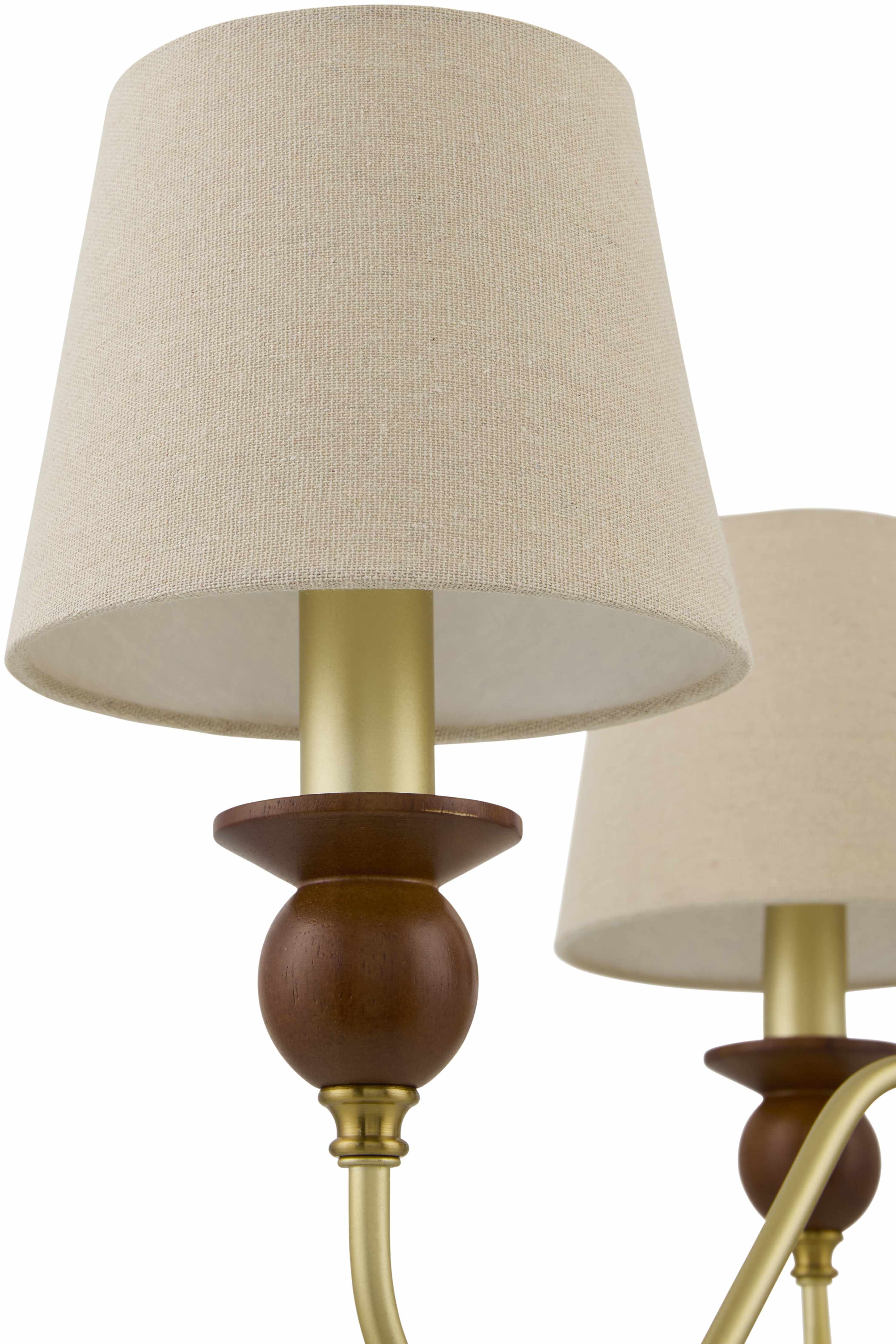 Pair of wall-mounted lamps with beige lampshades and bronze and gold bases on a white background