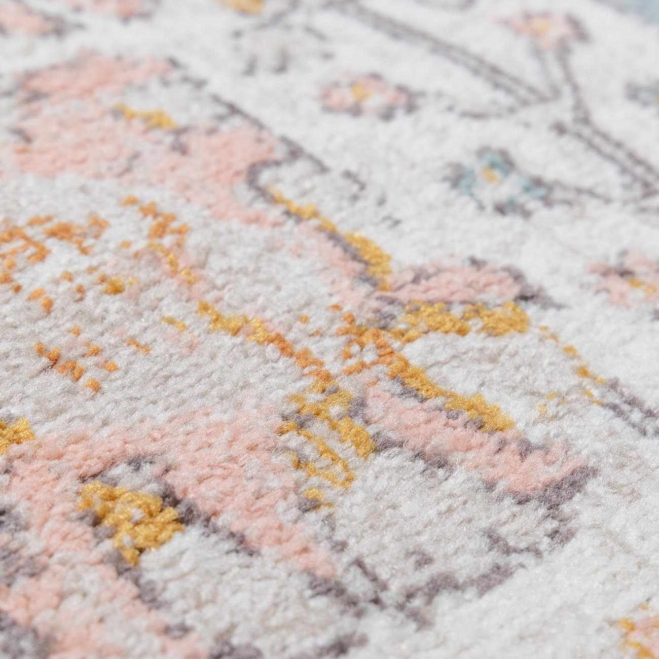 Close-up of a textured surface with pink, yellow, and gray patterns