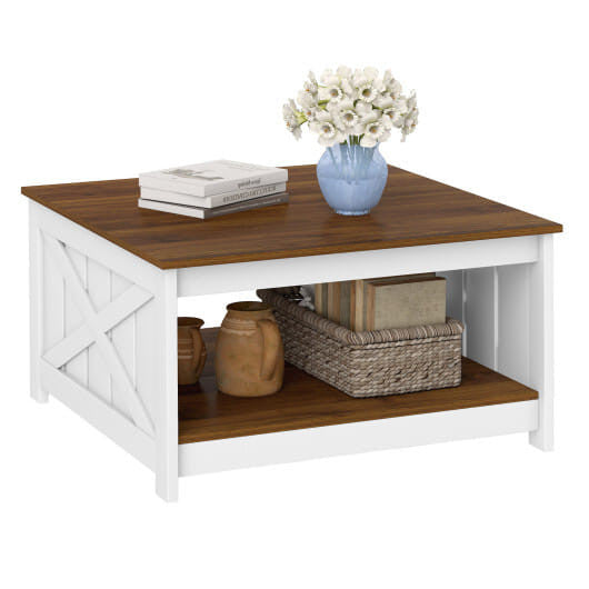 Wooden coffee table with a white base, featuring a vase of flowers, books, and decorative items on a white background.