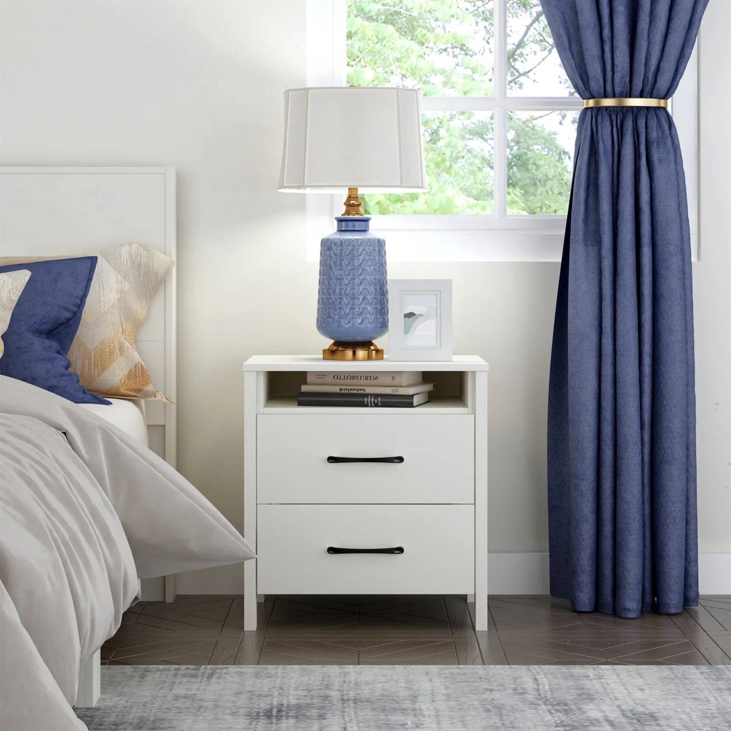 Bedroom with a nightstand, lamp, and blue curtains.