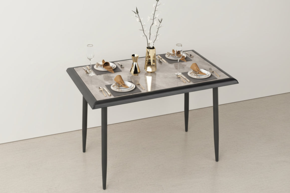 Dining table set with plates, cutlery, and a vase on a white background