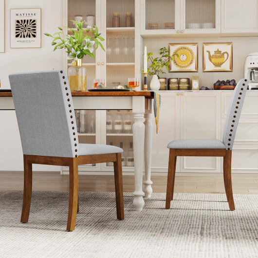 Dining room with wooden chairs and a table, featuring decor elements.