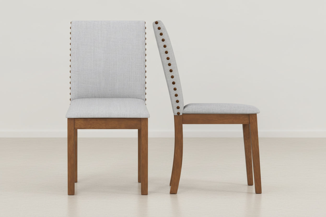 Two wooden chairs with gray cushioned seats on a white background