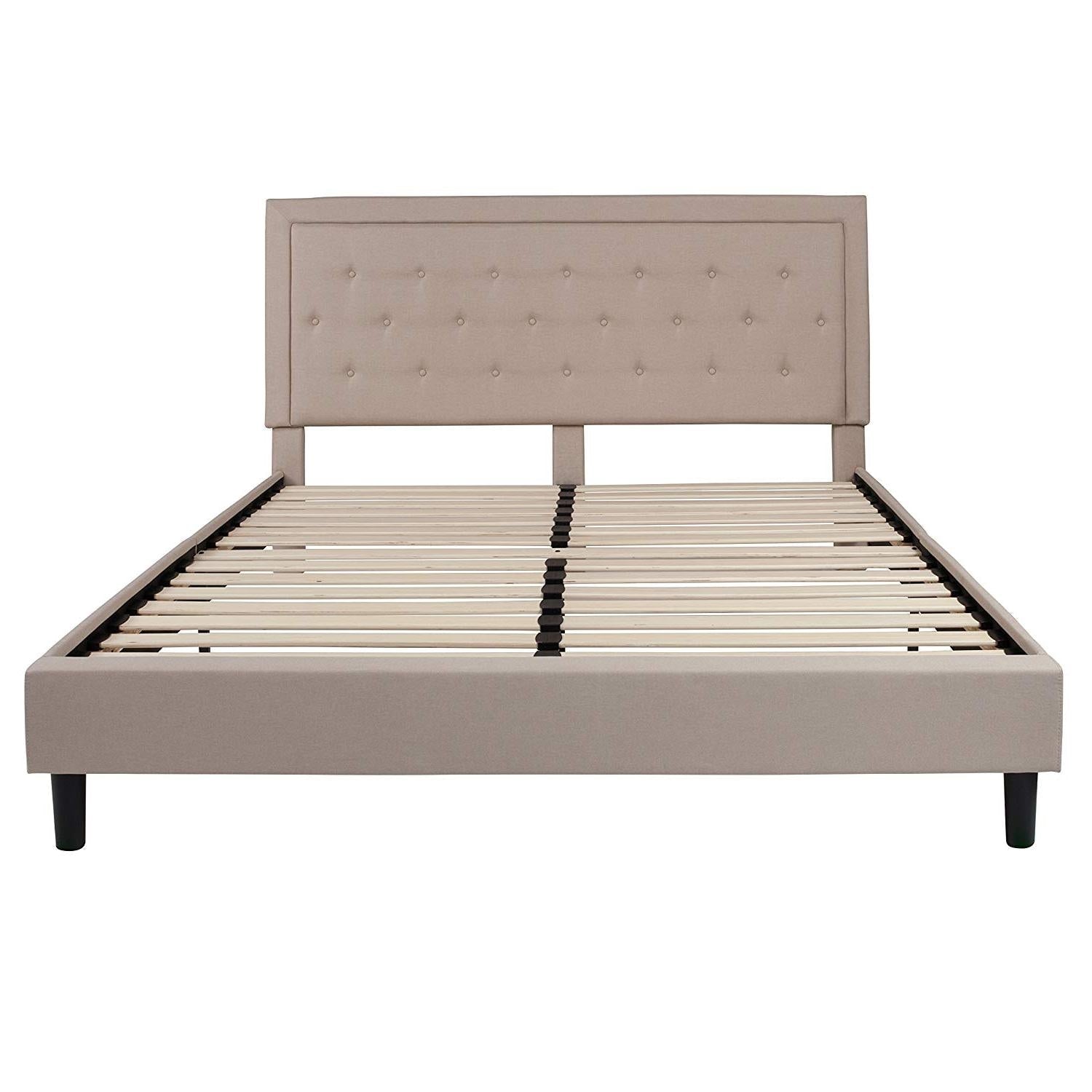 Beige upholstered bed frame with slatted bed base on a white background