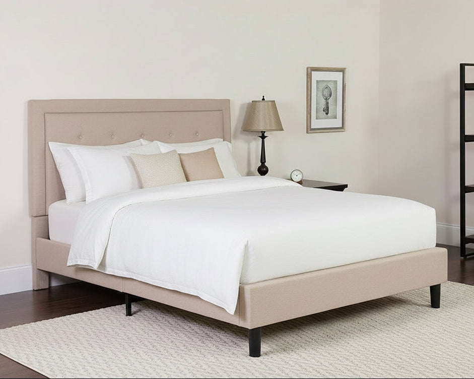 Beige bed with paisley bedding in a bedroom setting.