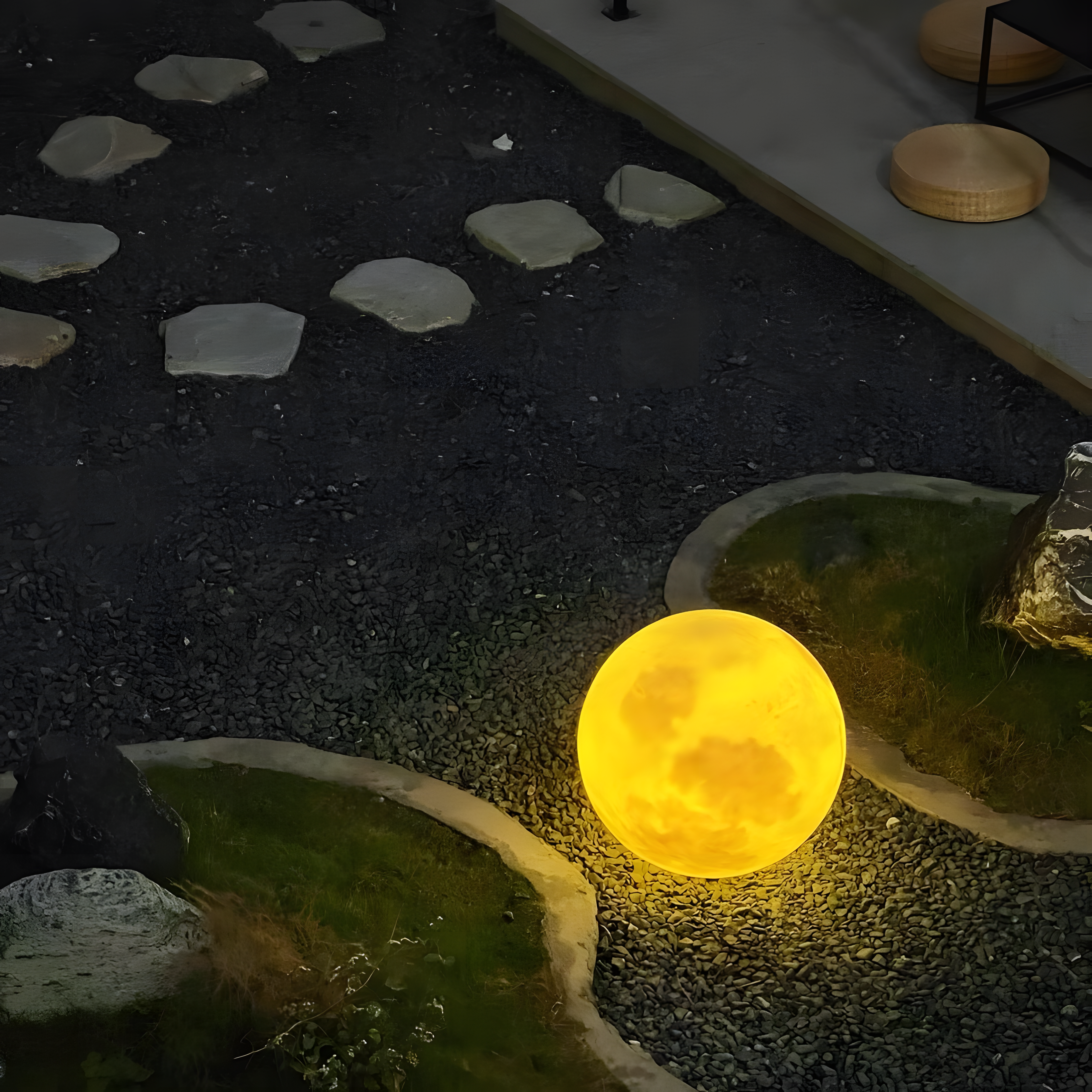 Glowing yellow moon-shaped light on a stone pathway