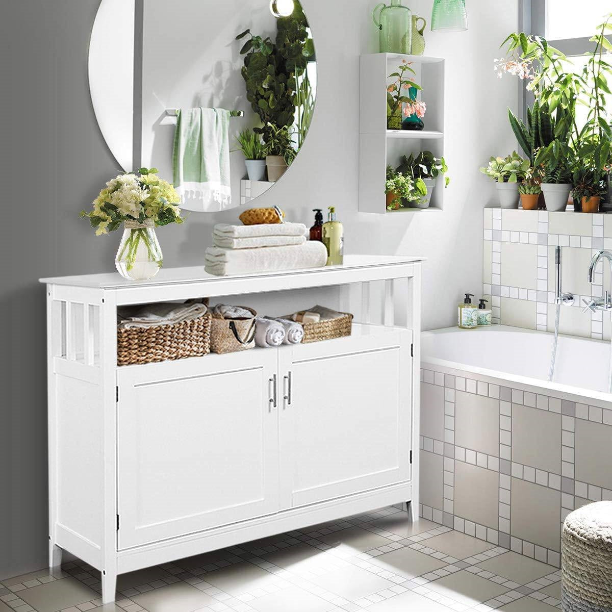 Bathroom with a white cabinet, sink, and various plants.