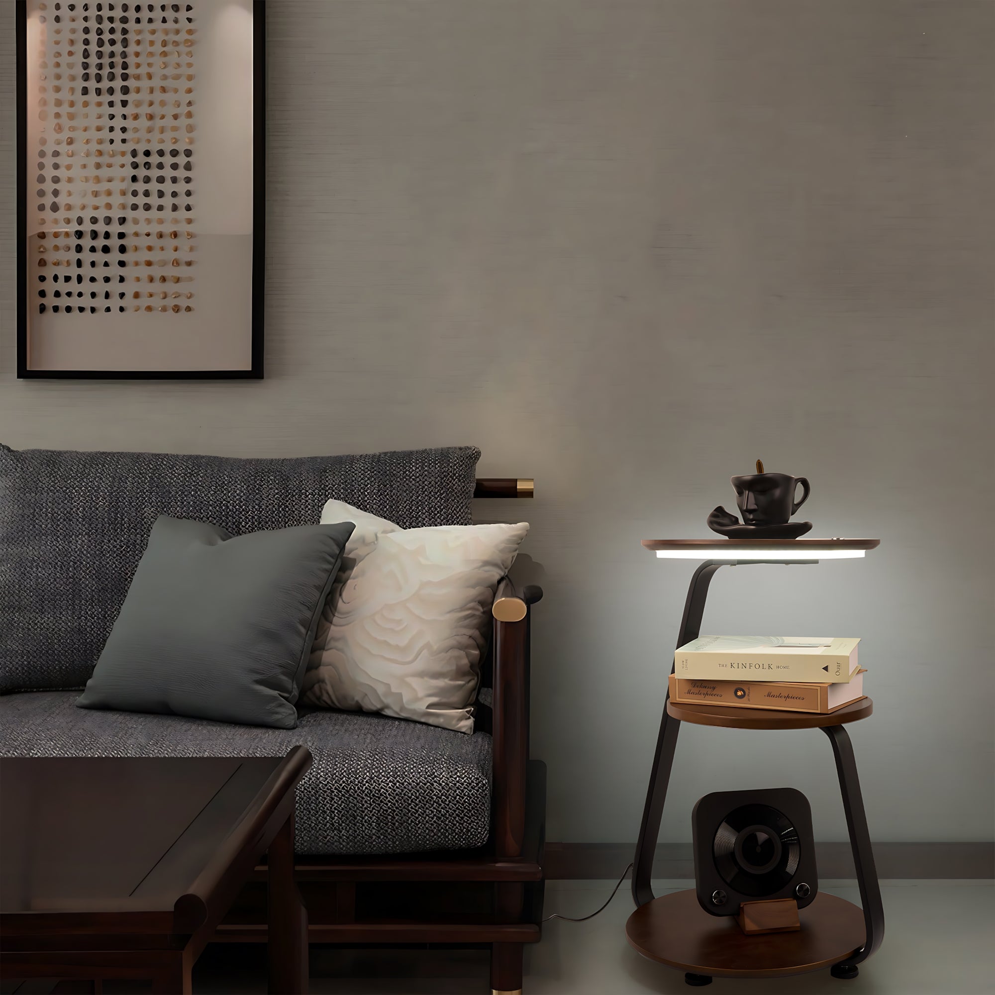 Modern living room with a gray sofa, side table, and decorative items.