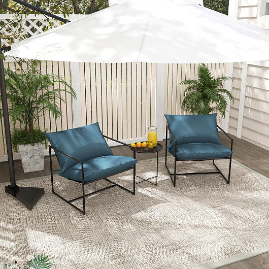 Outdoor patio set with two blue chairs, a small table, and a large white umbrella on a deck.
