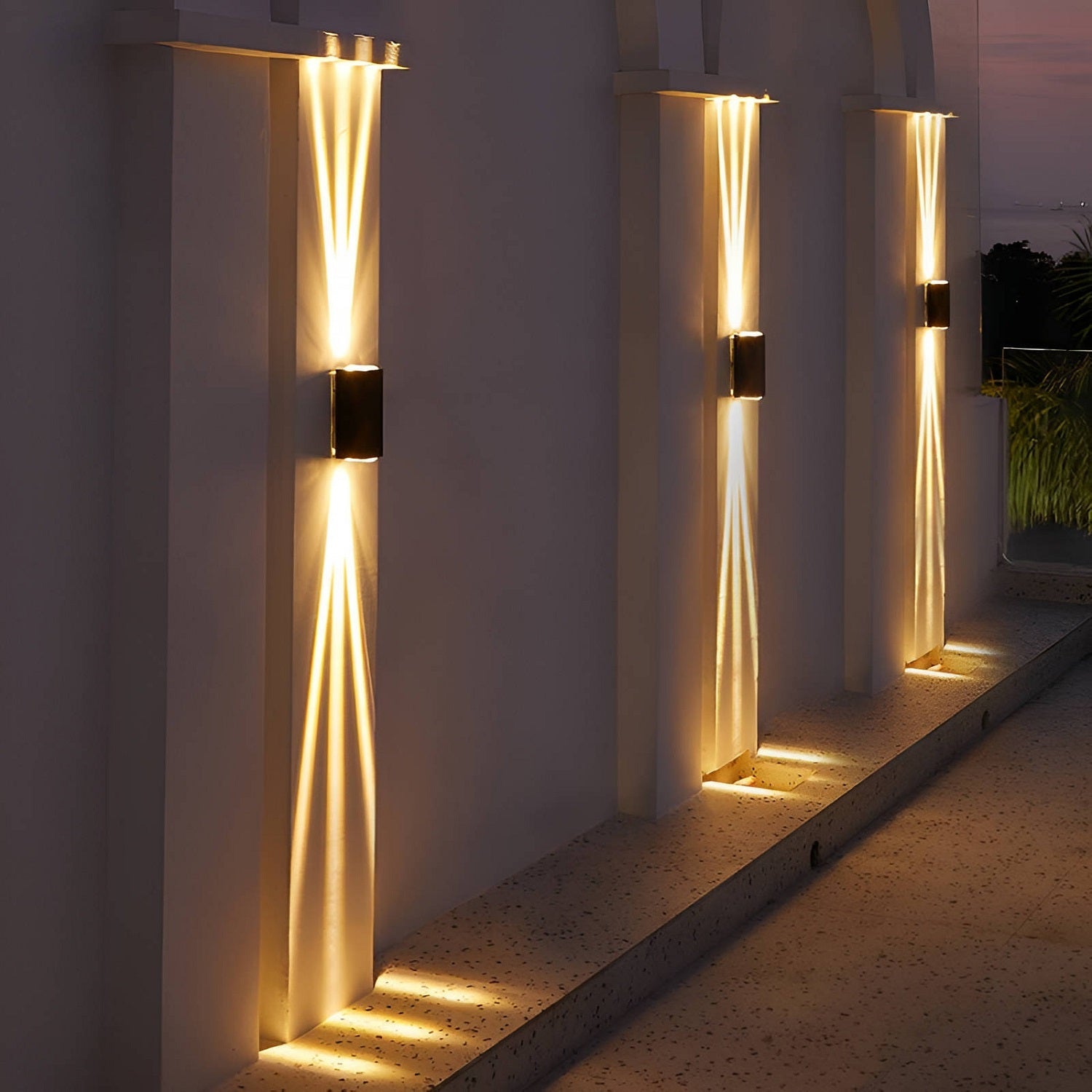 Modern outdoor wall lights on a white wall with a scenic background
