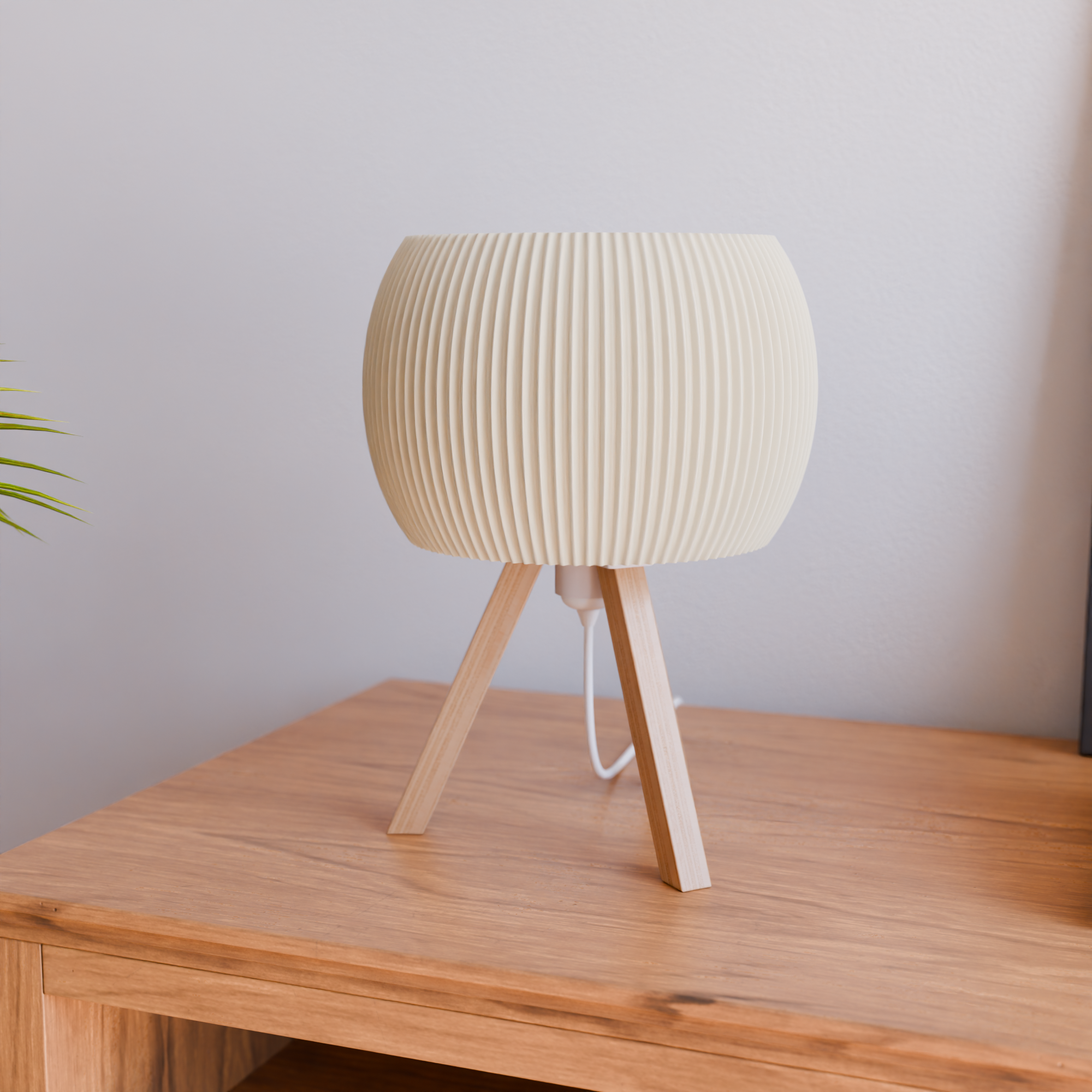 Wooden table lamp with ribbed design on a wooden surface against a light gray wall.