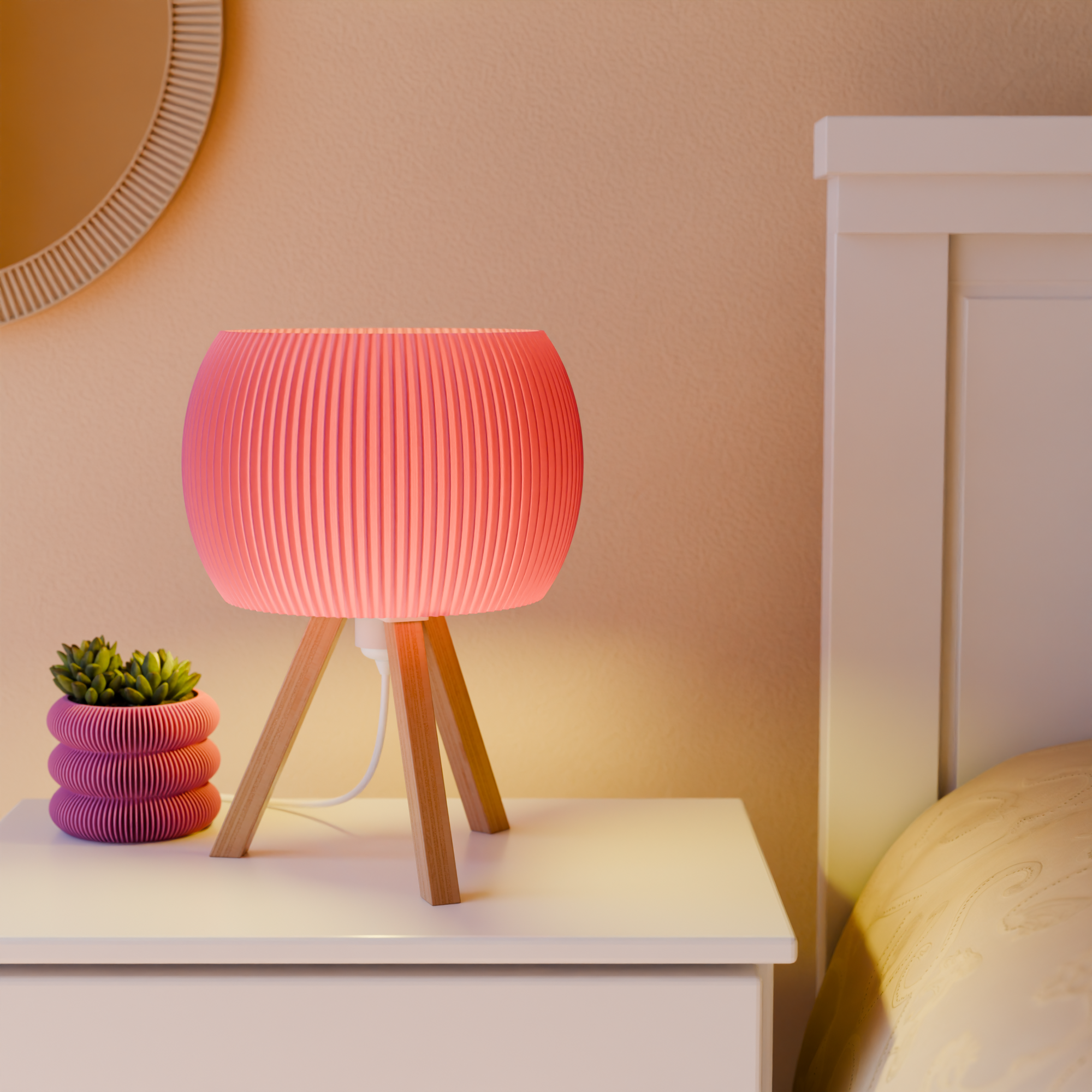Pink table lamp on a nightstand with a plant, next to a bed.