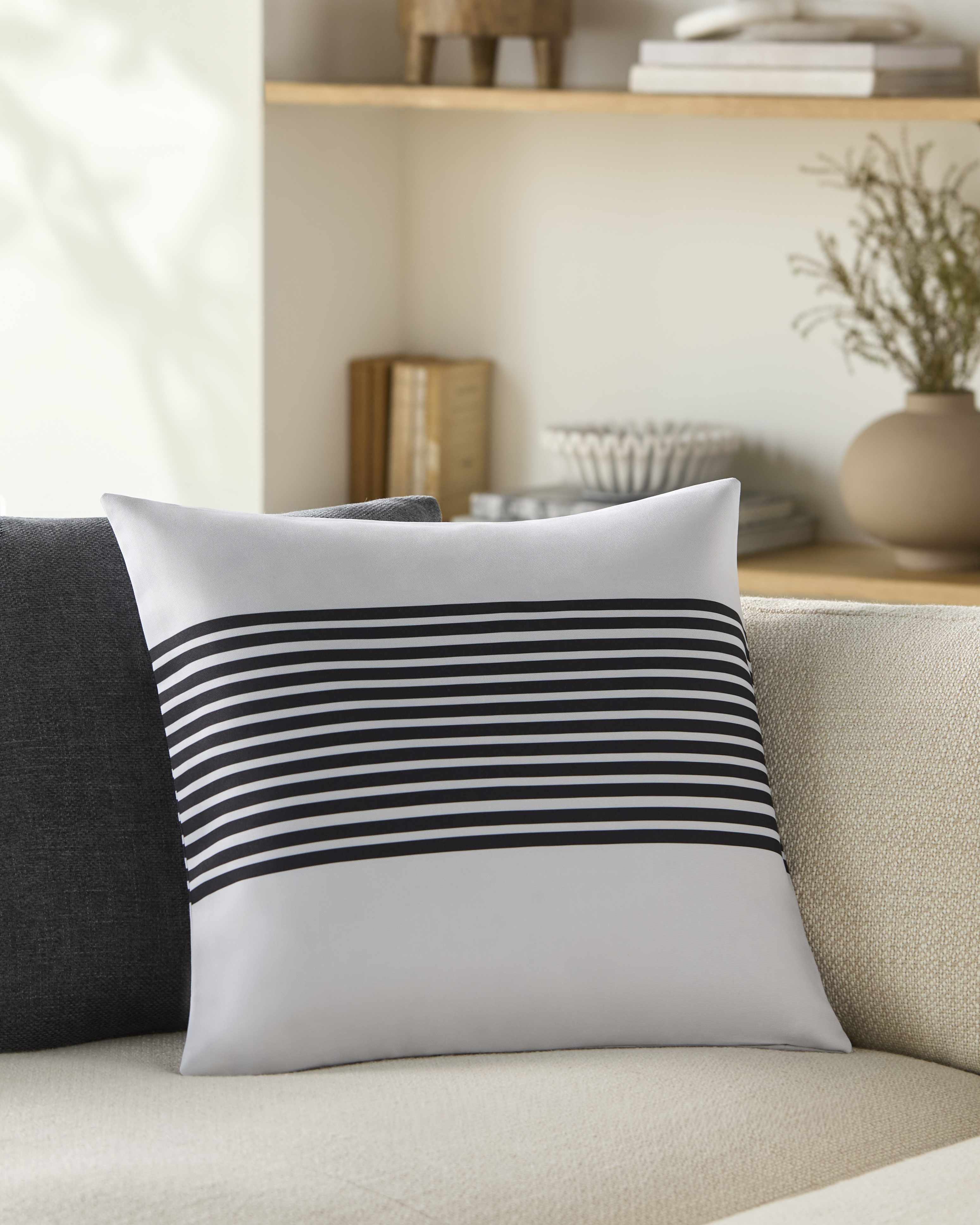 Striped pillow on a couch with a blurred background