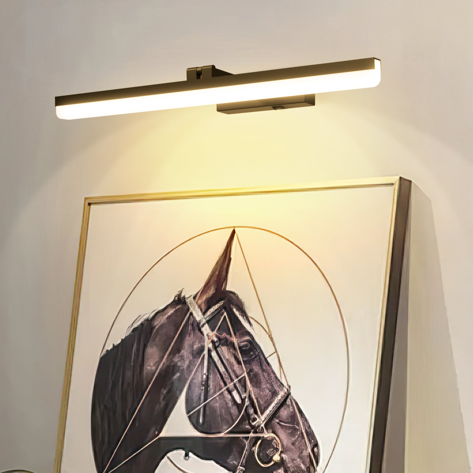 Wall-mounted light fixture above a framed picture of a horse's head.