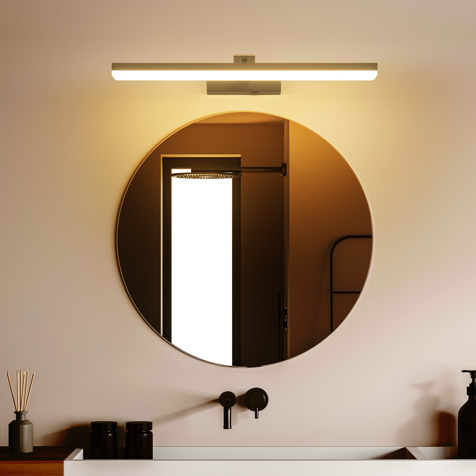 Round mirror with a light fixture above it in a bathroom setting.