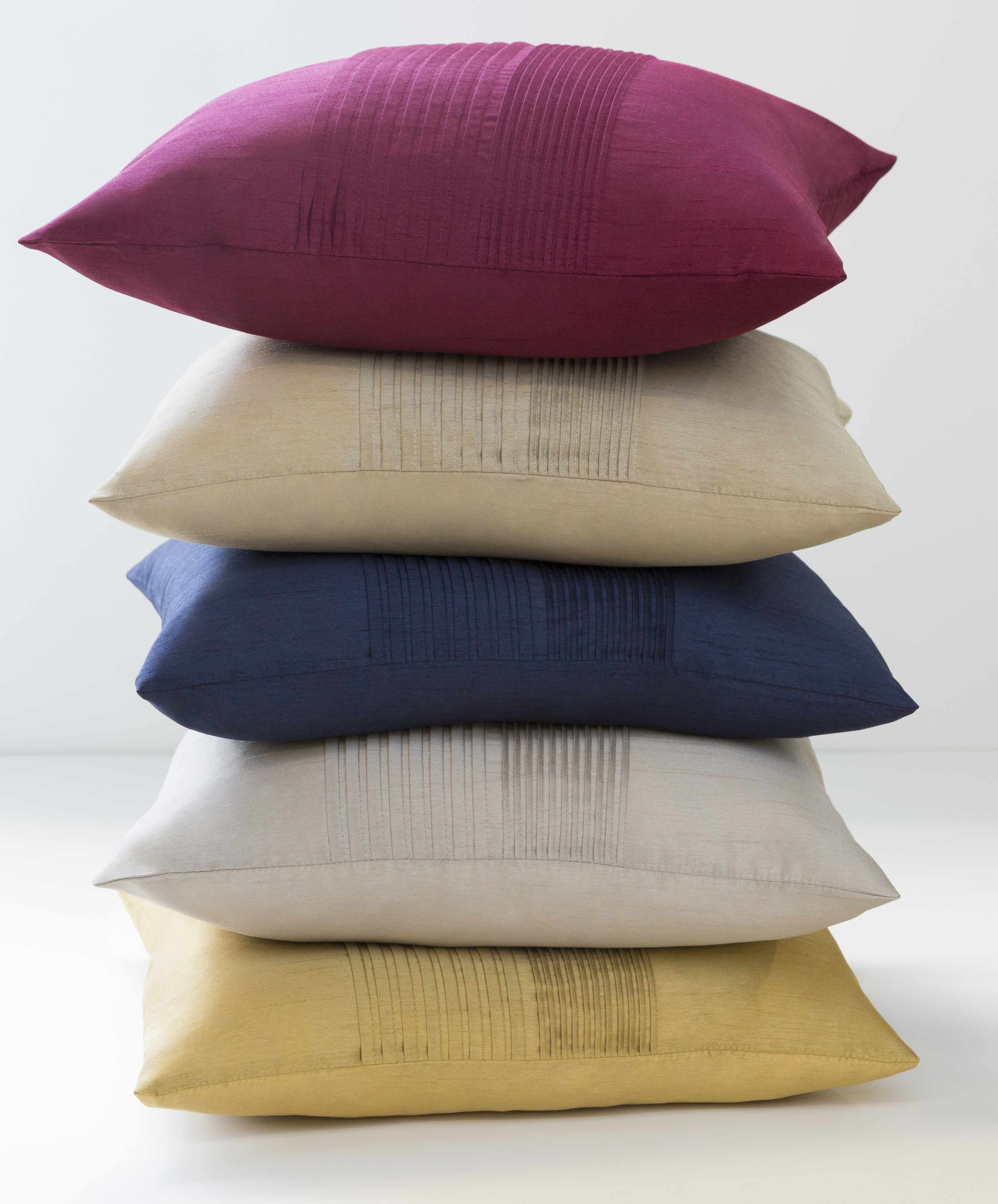 Stack of five multicolored pillows on a white background