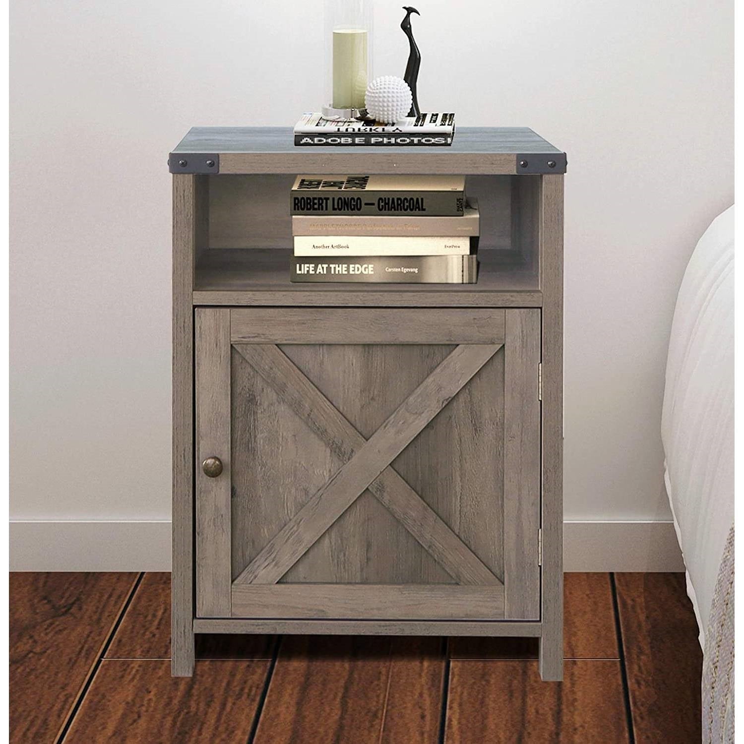 Wooden nightstand with a cabinet and open shelf against a white wall.