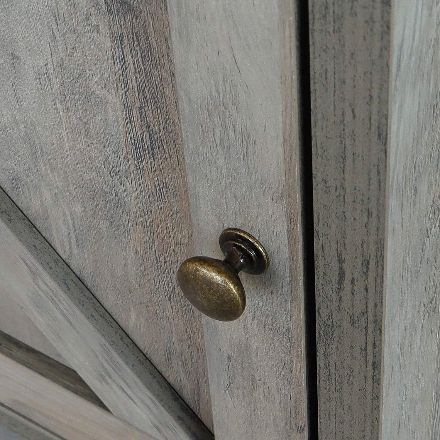 Close-up of a wooden cabinet with a brass knob