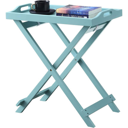 Light blue folding side table with a cup and books on a white background