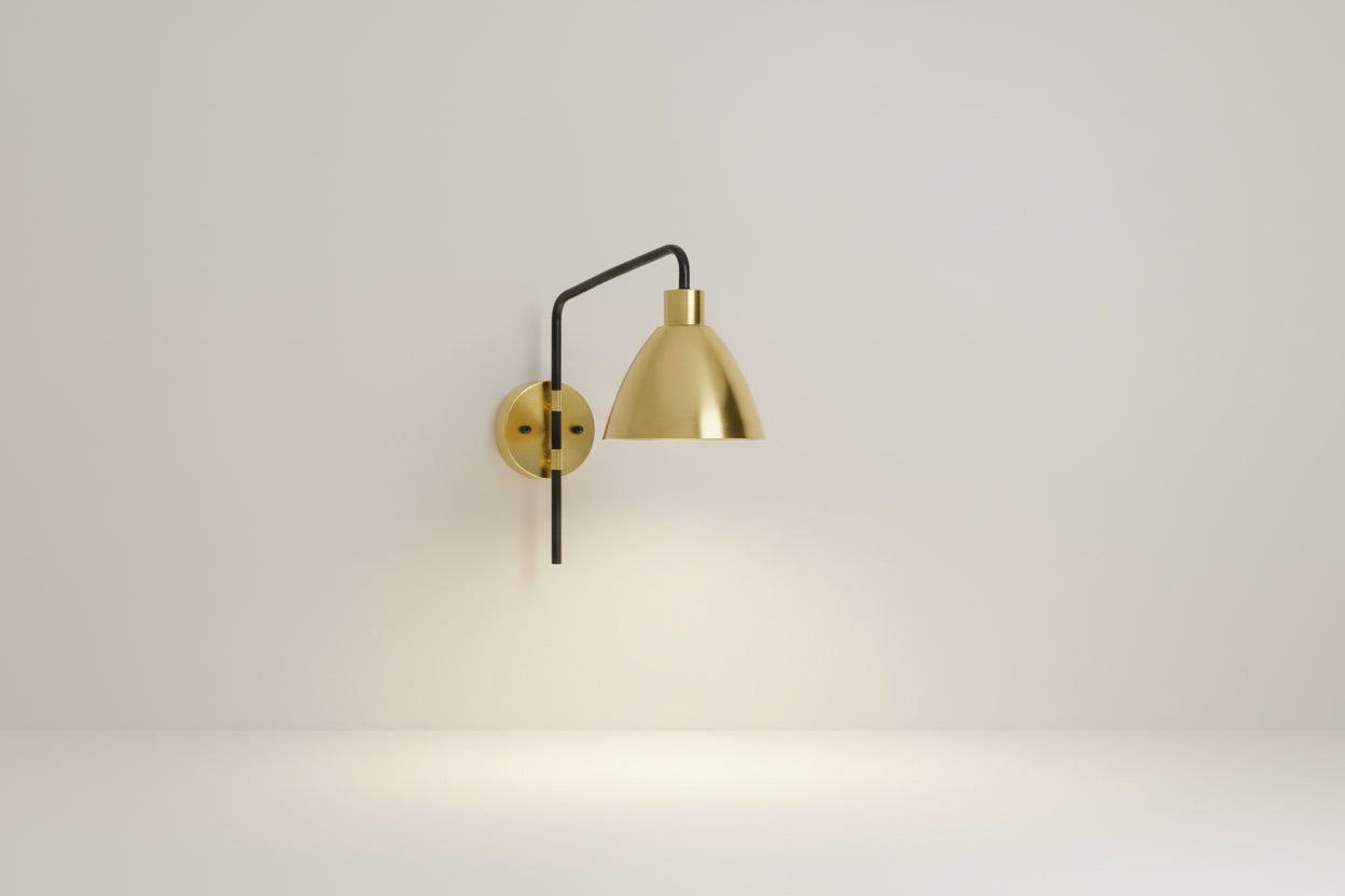 Gold wall-mounted lamp with black accent on a white background