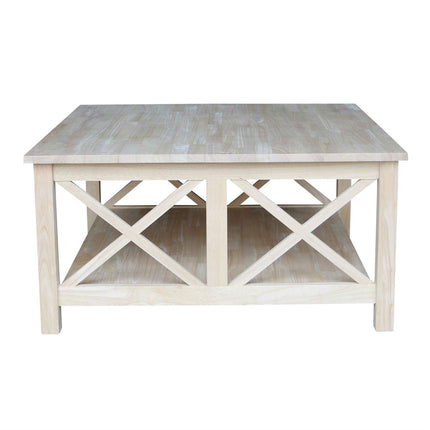 Light wooden coffee table with x-shaped design on a white background