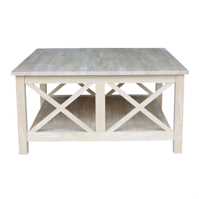Light wooden coffee table with x-shaped design on a white background