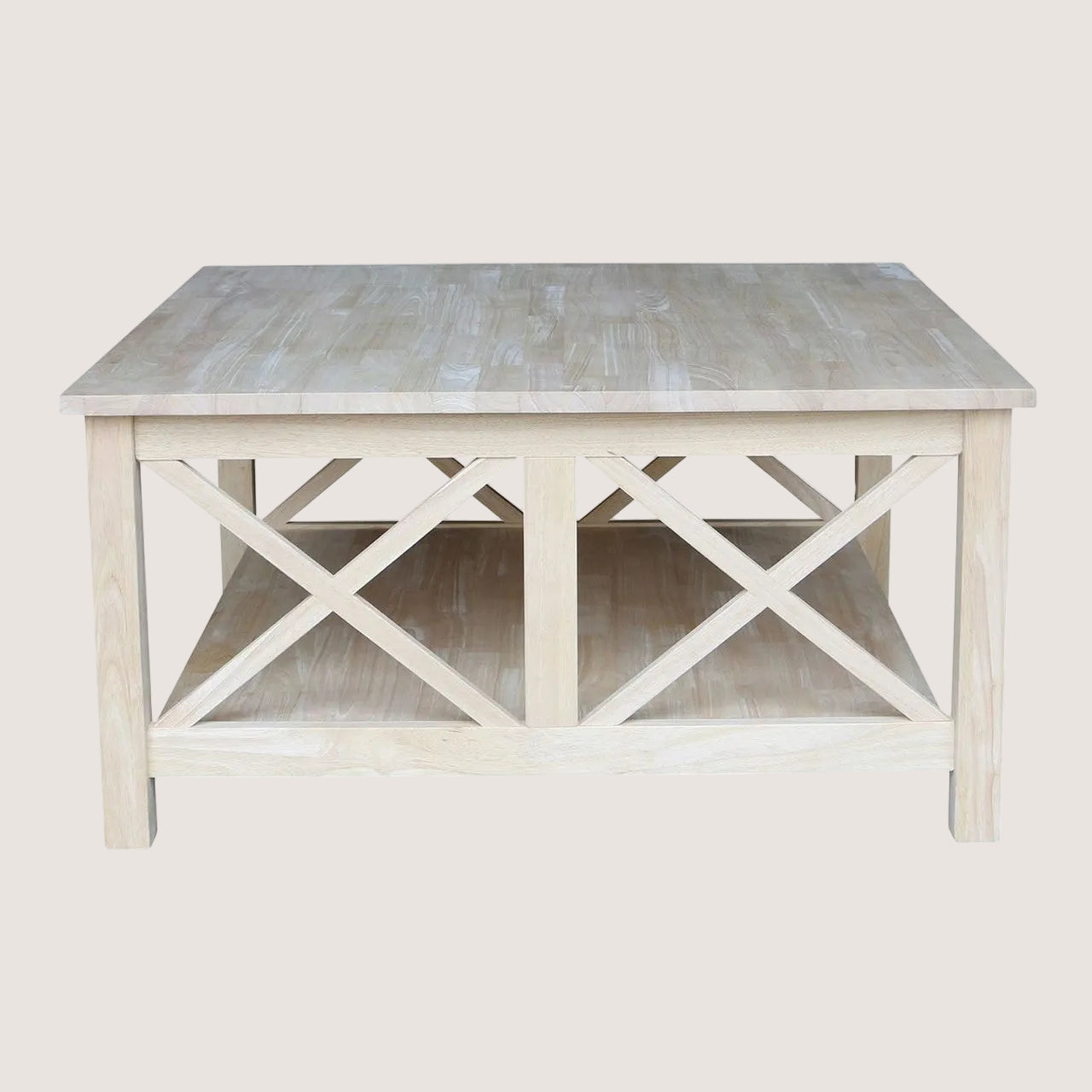 Light wooden coffee table with x-shaped design on a white background